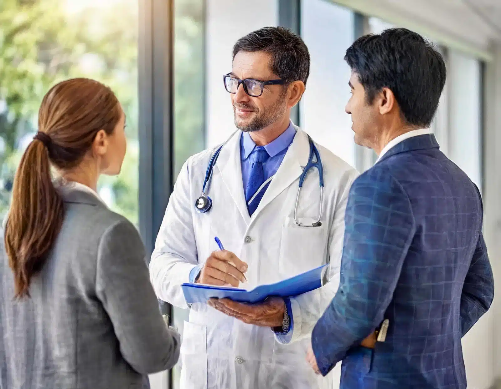 Two professionals from Element Staffing Registry with a doctor discussing medical staffing solutions
